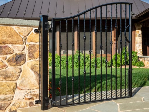 black metal gate opening to the entrance of a building