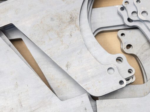 close up of custom steel parts with curves and holes