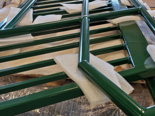 green metal railing lying on ground ready for installation