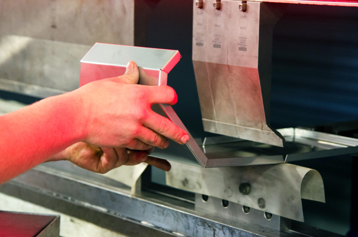 fabricator utilizing a tool to bend sheet metal