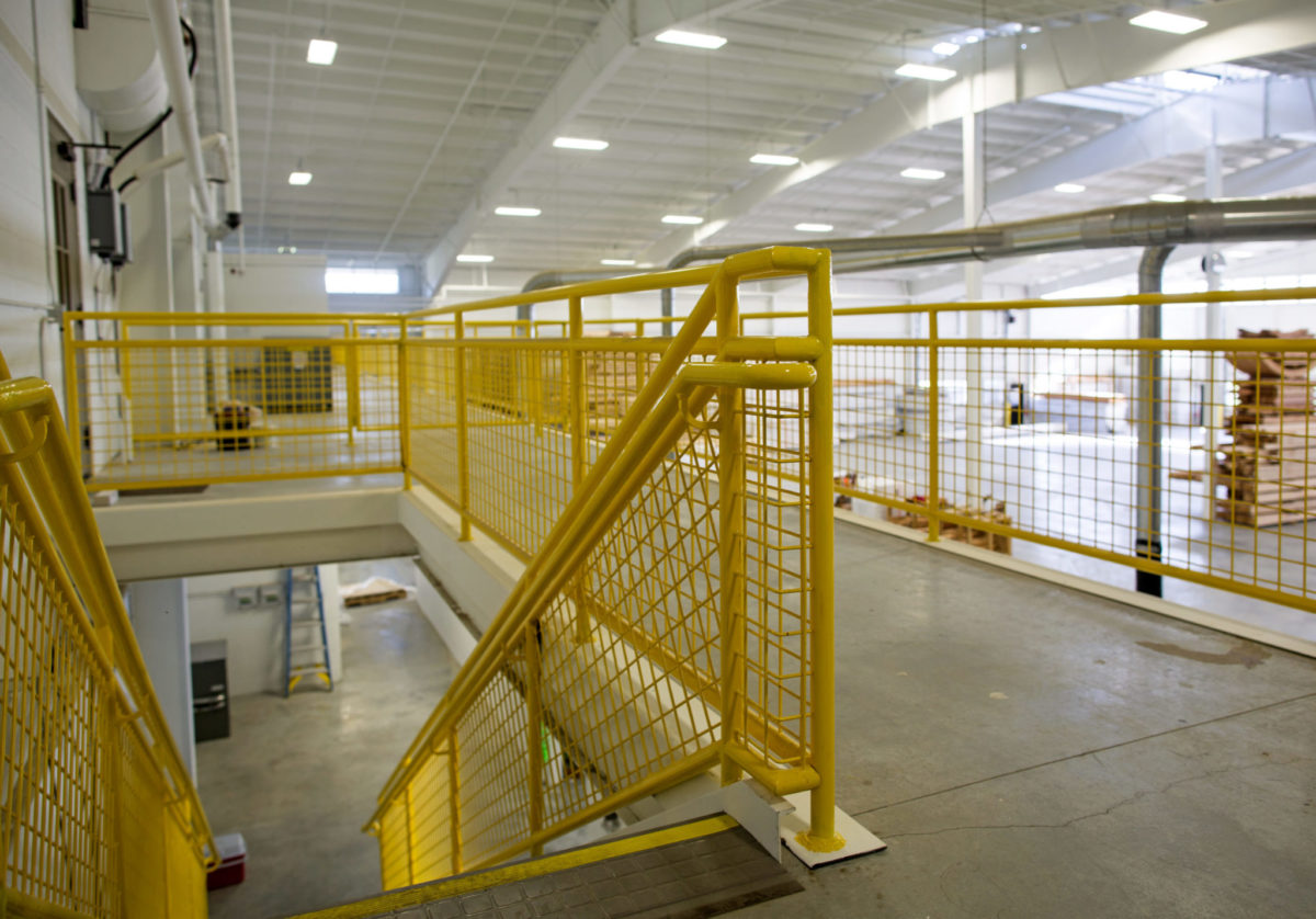 yellow metal stair railing in a big warehouse