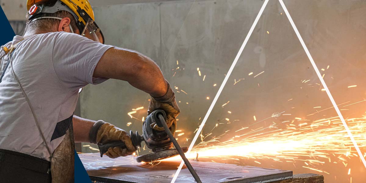 a worker fabricating a piece of metal